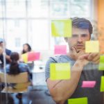 Close-up of male executive reading sticky notes